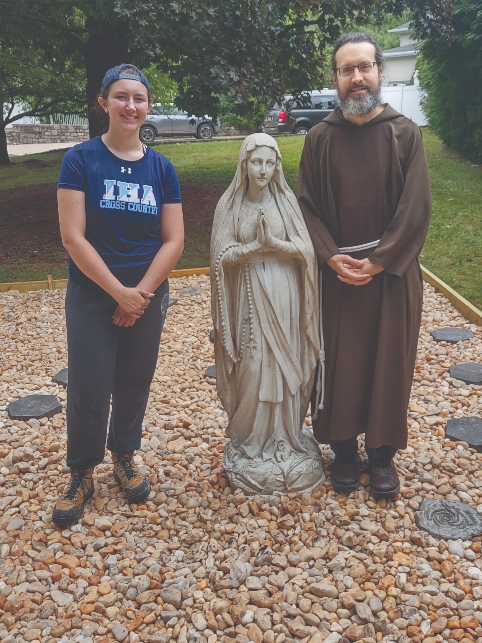 Abby Bennett and Br. Anthony Zuba in St. Conrad Friary’s newly completed rosary garden.